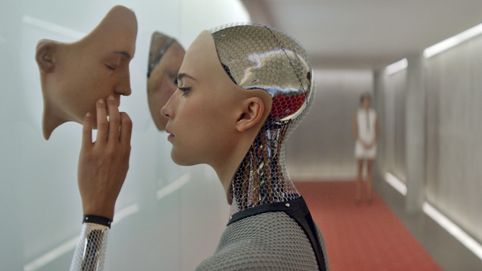 ava from ex machina, touching a model of her own face